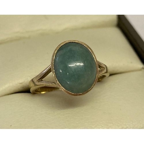 1081 - A 9ct gold dress ring set with an oval cabochon of green jade.  Hallmarks to inside of band. Ring si... 