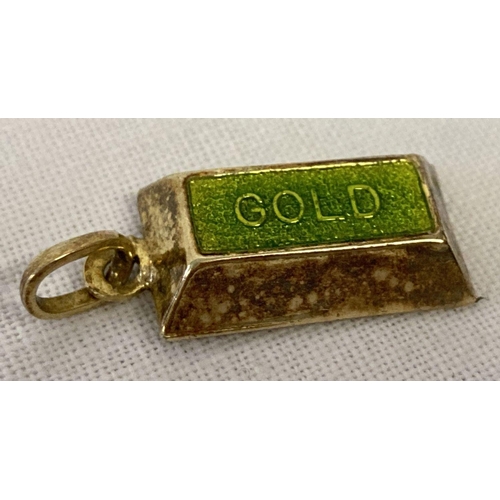 1085 - A gold charm/pendant with bale in the shape of a gold bar with green enamel to top. Tests as 9ct.  A... 