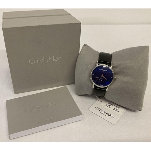 1125 - A boxed ladies wrist watch by Calvin Klein.  Silver tone case with blue face. Silver tone hands and ... 