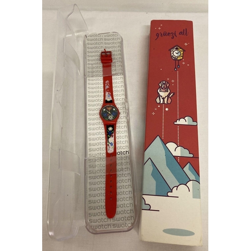 1138 - A boxed Swatch watch. Red plastic strap with floral detail to both face and strap. In working order.... 