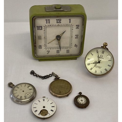 1139 - A modern design ball clock together with a vintage green painted alarm clock.  Lot also includes poc... 