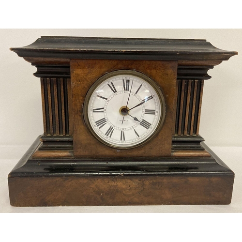 1141 - A vintage wooden cased clock with column detail, fitted with a modern quartz movement. Working order... 