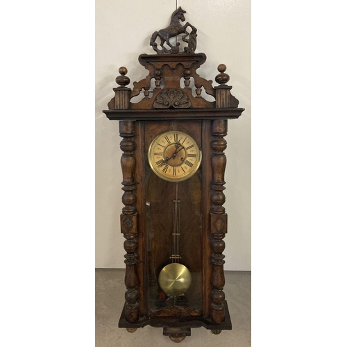 1142 - An antique dark wood cased Vienna style wall clock with glass panelled case.  Turned detail to woode... 