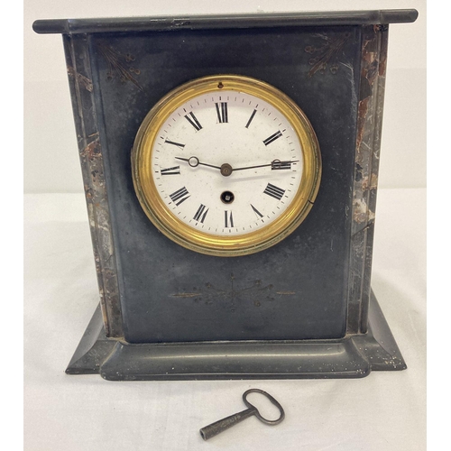 1152 - An antique black slate and marble mantle clock complete with key and pendulum.  Enamelled face, glas... 