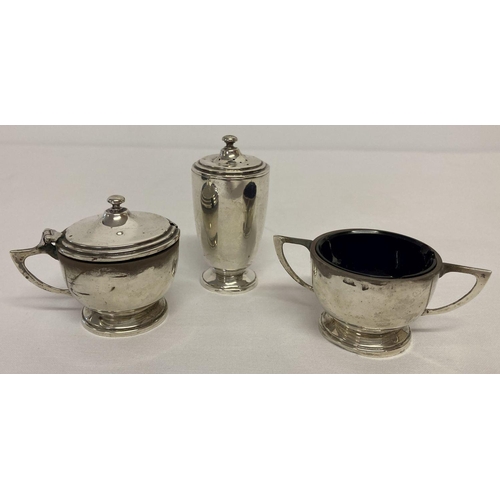 1174 - An Art Deco design hallmarked silver 3 piece cruet set with blue glass liners.  Hallmarked Birmingha... 