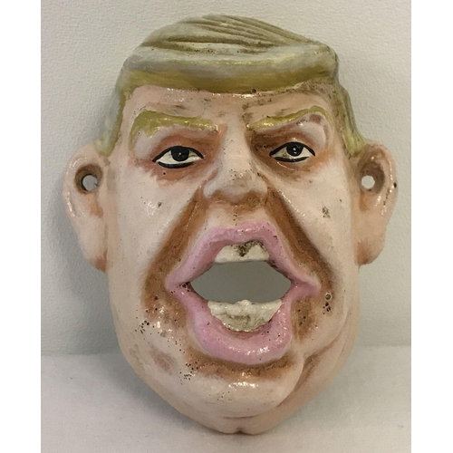 1195 - A painted cast metal wall hanging bottle opener in the shape of Donald Trump.   Approx. 10.5cm long.