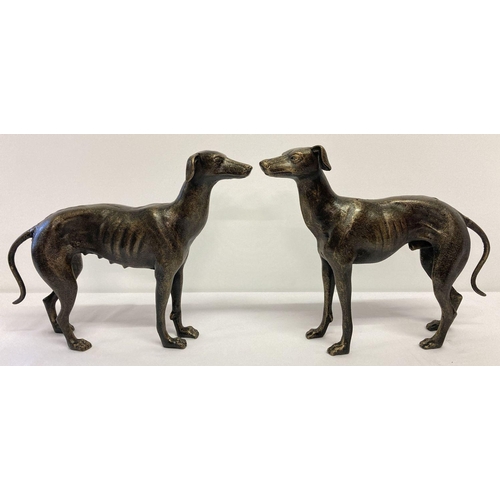 1201 - A large pair of cast metal bronzed effect greyhound figurines.   Approx. 30cm tall x 33cm long.