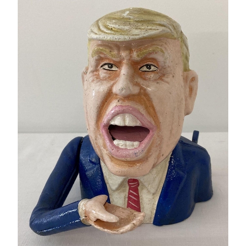 1202 - A painted cast metal novelty money bank in the form of Donald Trump.  With swinging arm action.  App... 