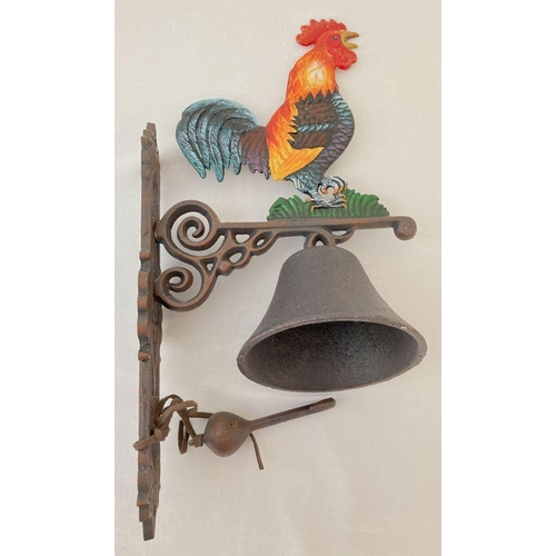 1204 - A painted cast metal wall hanging garden bell with cockerel detail.   Approx. 42cm tall.