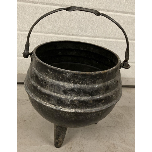 1211 - A vintage metal 3 legged cauldron pot with carry handle.   Approx. 43cm tall with handle x 27.5cm di... 