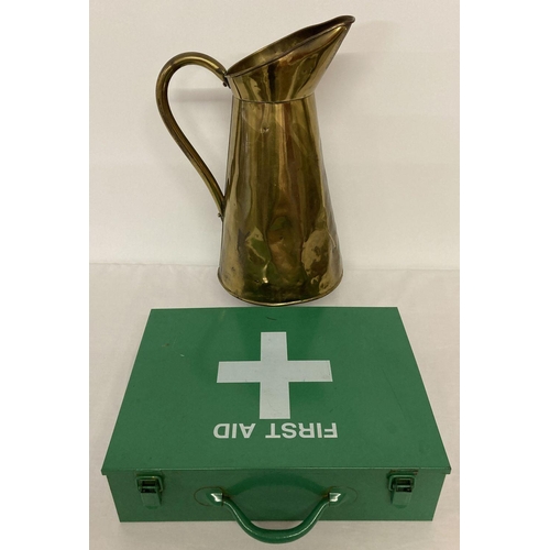 1218 - A large vintage brass jug together with a green metal first aid box with carry handle.   Jug approx.... 