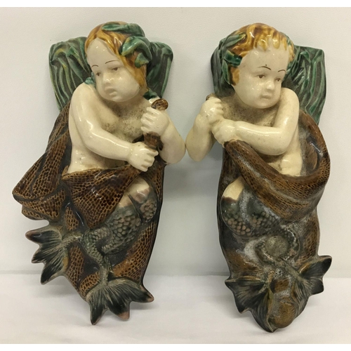 1226 - A pair of mermaid and merboy majolica glazed ceramic wall pockets.   Approx. 24cm tall.