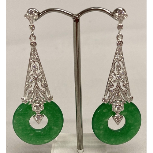 7 - A pair of 925 silver and jade drop earrings.  2.25cm diameter jade disc pendants suspended from a si... 