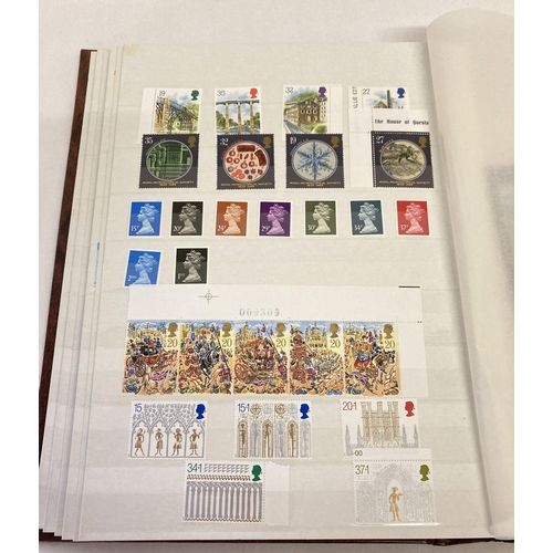 204 - A large brown album containing 400 British unused stamps and 8 first day covers.  Stamps include set... 