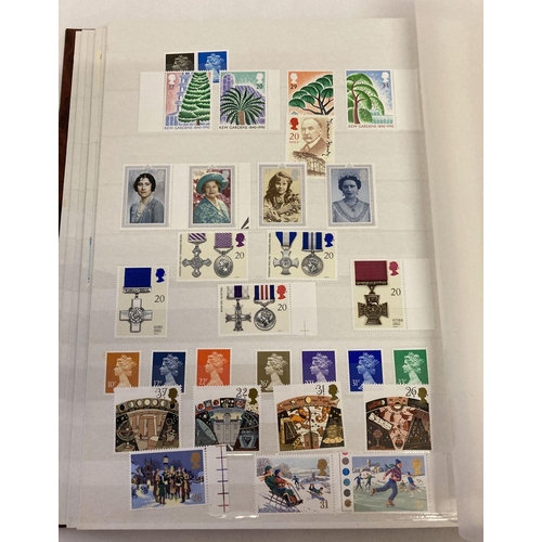 204 - A large brown album containing 400 British unused stamps and 8 first day covers.  Stamps include set... 