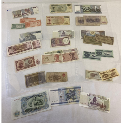 34 - 30 vintage foreign bank notes.  To include examples from: Hong Kong, Italy, Zimbabwe, Chile, China, ... 