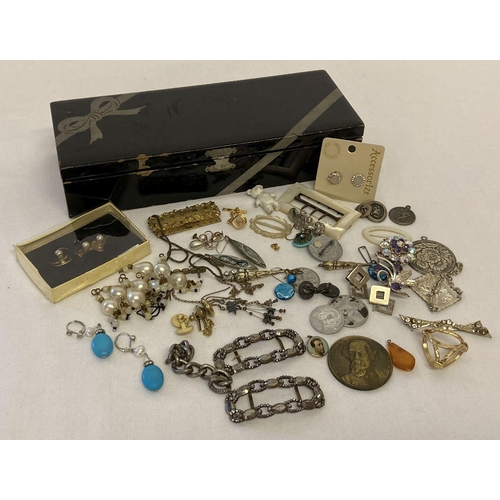 1056 - A vintage black lacquer box containing a collection of costume jewellery & mother of pearl buckles. ... 