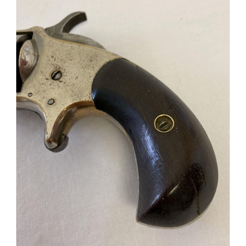117 - An antique .32 calibre Blue Whistler rim fire revolver with wooden grip. No. 6 and other indistinct ... 