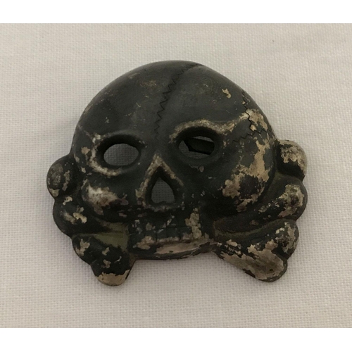 12 - A German WWII style Allgemeine SS Totenkopf skull badge - jawless type. With 2 slider fixings to rev... 