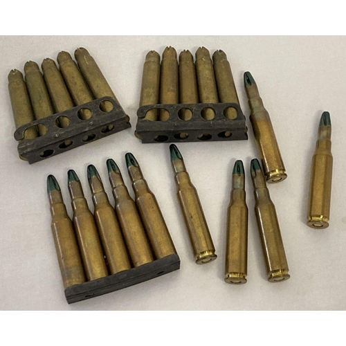 121 - A collection of blank brass bullets. 10 x 7.62 of which 5 are in a clip. Together with 10 x .303 hel... 