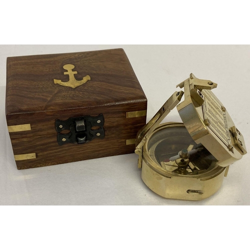 135 - A reproduction brass Natural Sine compass with internal mirrored lid, marked Stanley, London. In woo... 