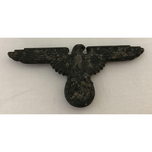 14 - A WWII style German Waffen SS cap eagle with markings to reverse and 3 slider fixings.  Approx. 7cm ... 