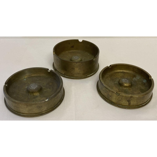 140 - 3 large trench art ashtrays made from brass shell bases. Marked to bases 8 65 556AK, 2 65 556AK and ... 