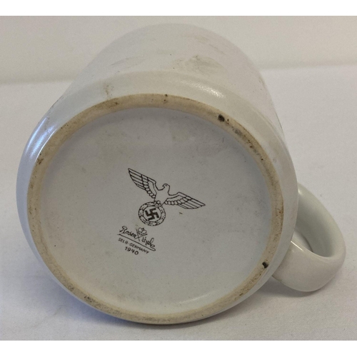 160 - A WWII style German ceramic mug with printed details to base. Some damage to glaze on one side. Appr... 