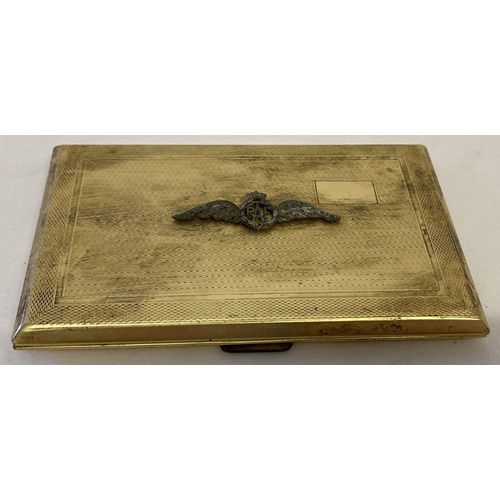 167 - A vintage gold tone cigarette case set with metal R.A.F Pilots winged badge. Clasp to case not worki... 