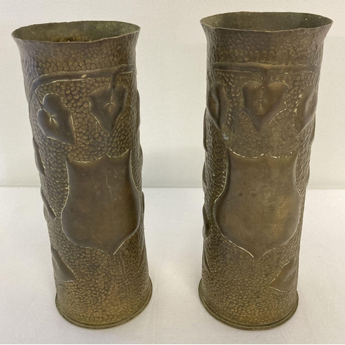 212 - A pair of WWI era trench art shell case vases with hammered effect and ivy leaf detail.  Approx. 23c... 