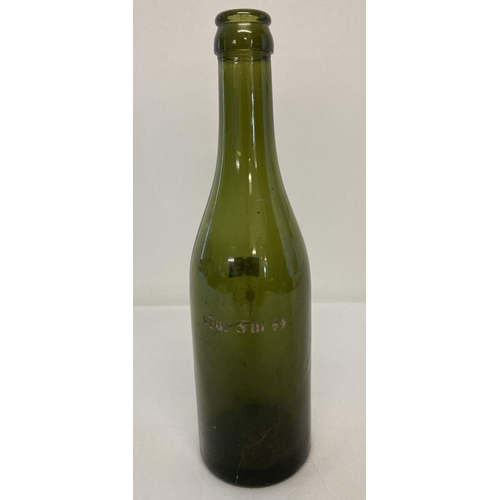 222 - A WWII style German green glass beer bottle with engraved detail 