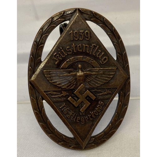 36 - A German WWII style N.S.F.K. competition pin back badge.  Approx. 4.5cm x 3.25cm.