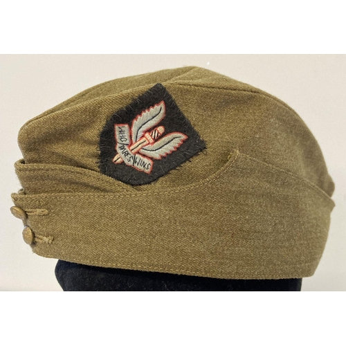 61 - A WWII style British army side cap with hand embroidered S.A.S cap badge sewn on it.