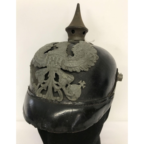 65 - A WWI style Imperial German-Prussian Mle Pickelhaube. Leather helmet and peak with metal badge, spik... 