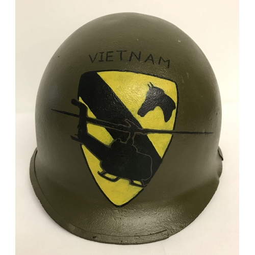 67 - A Vietnam War era M1 helmet with post war hand painted memorial to the 1st Air Cavalry. The helmet w... 