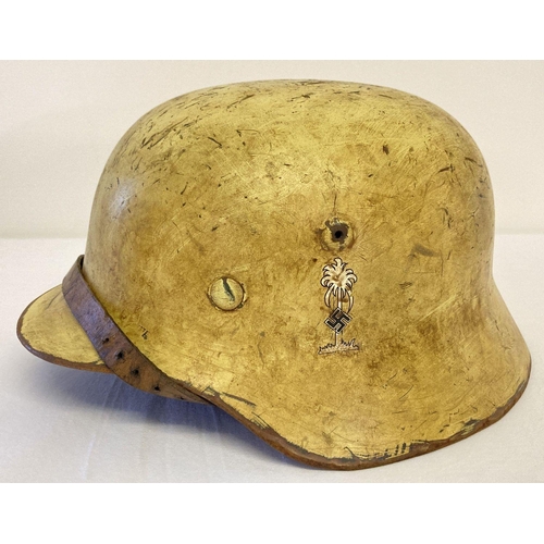 73 - A WW2 style German Africa Corps helmet with liner and chin strap.