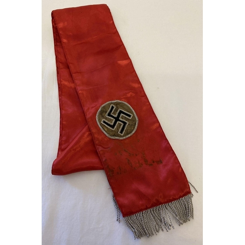 77 - A German WWII style red satin sash with bullion detail and tassels.  Approx. 173cm long (to inc. tas... 
