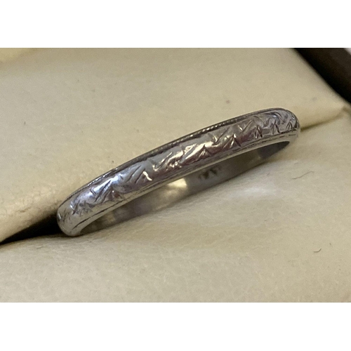 5 - A 2mm platinum wedding band with engraved pattern, size N½. Marked 'Plat' to inside of band. Total w... 