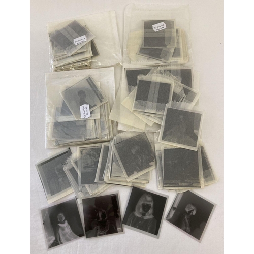 113 - A collection 200 assorted photographic negatives of clothed glamour models.