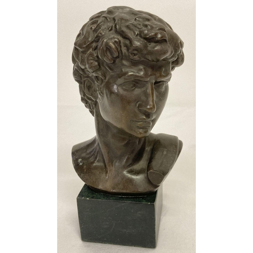 1022 - A small bronze bust of David mounted on a square shaped marble base.  Approx. 17.5cm tall.