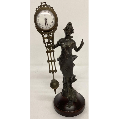 1061 - A bronze based figural, swinging pendulum mystery clock. In the form of an Art Nouveau style woman, ... 