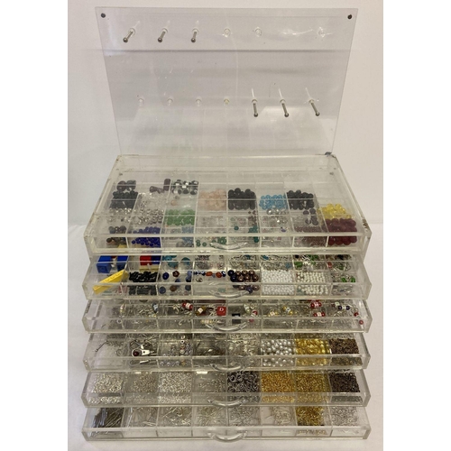 1023 - A jewellery makers Perspex chest of drawers and hanging hooks back panel. Containing a large quantit... 