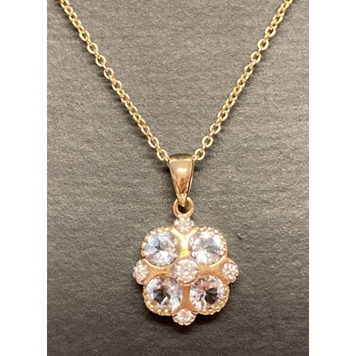 1029 - A 9ct gold aquamarine and diamond pendant necklace by Luke Stockley, London. A circular design penda... 
