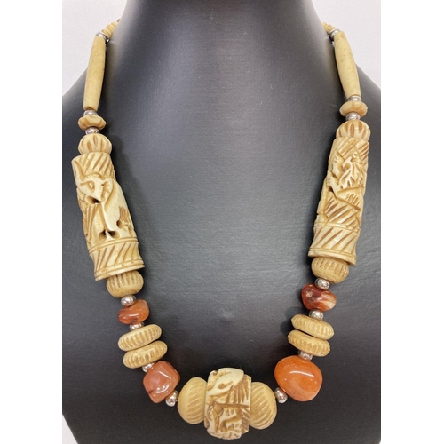 1031 - A carved bone and natural agate statement necklace with screw barrel clasp. Large bone beads carved ... 