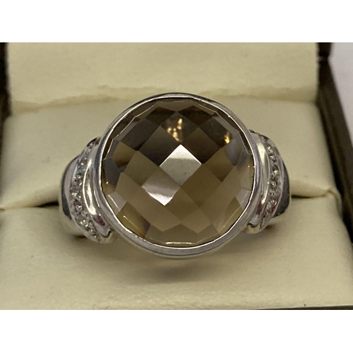 1037 - A silver cocktail ring set with checkerboard cut smoked quartz and diamonds. Central round bezel set... 