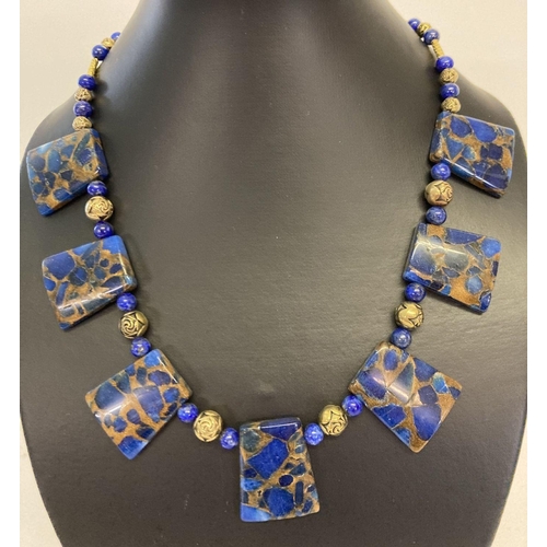 1040 - A boxed lapis Lazuli and gold tone bead Cleopatra style necklace with gold tone S shaped clasp.