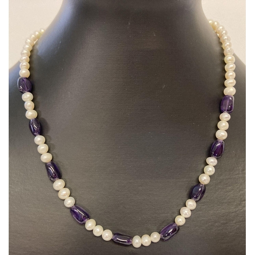 1057 - A freshwater pearl and amethyst beaded necklace with silver tone magnetic clasp.  Approx. 17