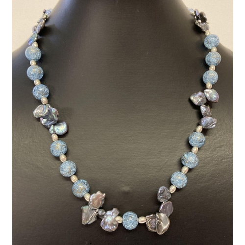 1072 - A blue rock crystal and freshwater peacock pearl necklace with silver tone magnetic barrel clasp.  A... 