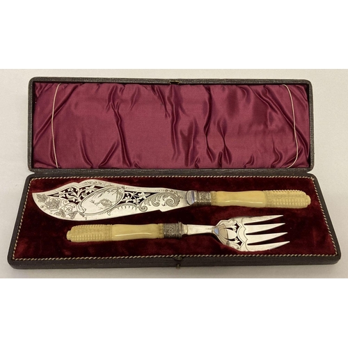 1132 - Antique silver plated fish servers with carved bone handles. Decorative engraved blade and prongs wi... 