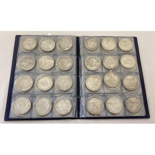 1133 - A folder containing 72 assorted white metal coins from around the world.  Folder approx. 21cm x 16cm... 